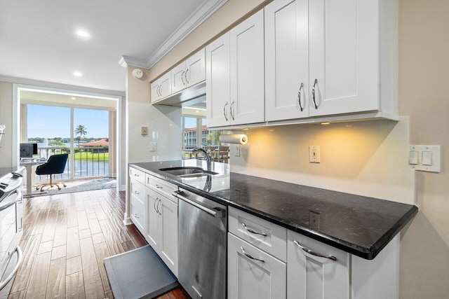 kitchen featuring stainless steel dishwasher, white cabinetry, a water view, and plenty of natural light