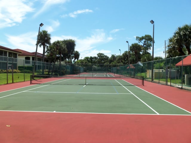 view of tennis court featuring basketball hoop