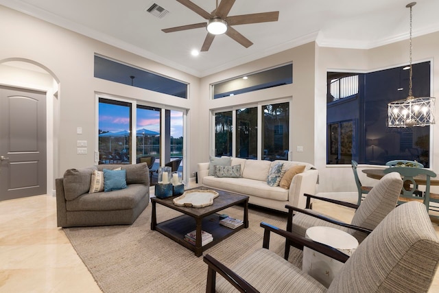 living room featuring ceiling fan with notable chandelier and ornamental molding