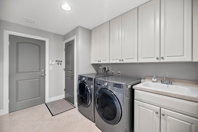 clothes washing area featuring cabinets, independent washer and dryer, light tile patterned floors, and sink