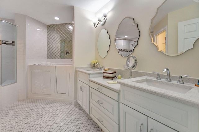 bathroom featuring vanity, tile patterned floors, and tiled shower