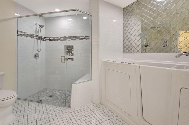 bathroom with separate shower and tub, toilet, and tile patterned floors