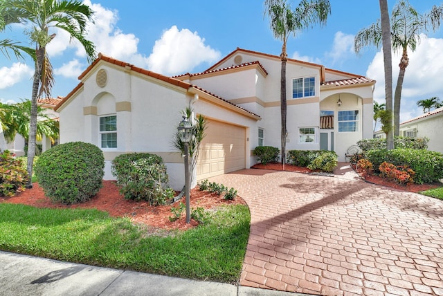 mediterranean / spanish-style house featuring a garage