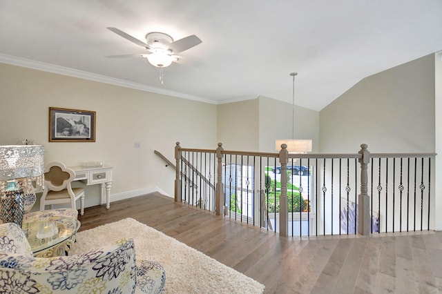 sitting room with crown molding, vaulted ceiling, ceiling fan, and dark wood-type flooring