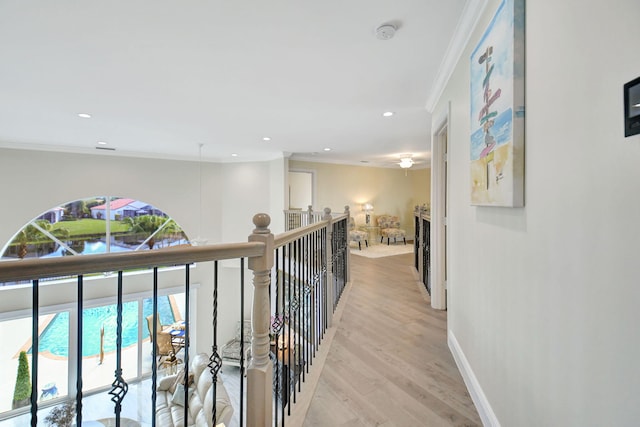 corridor with crown molding and light hardwood / wood-style flooring