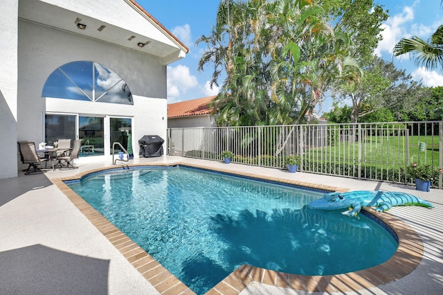 view of swimming pool featuring area for grilling and a patio area