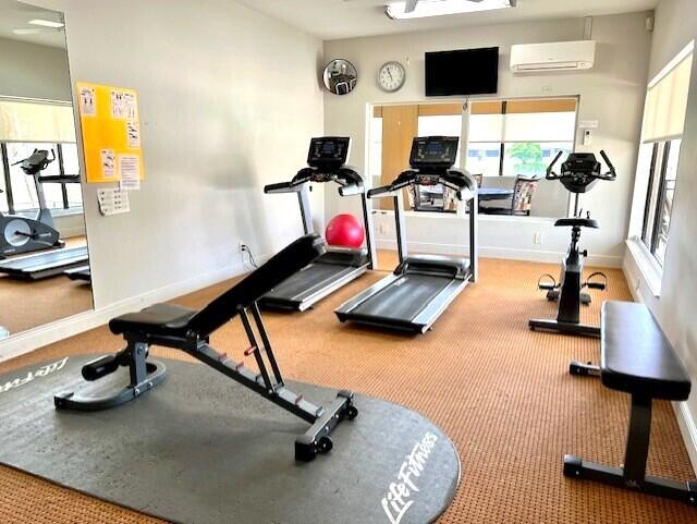 exercise room with a wall mounted air conditioner