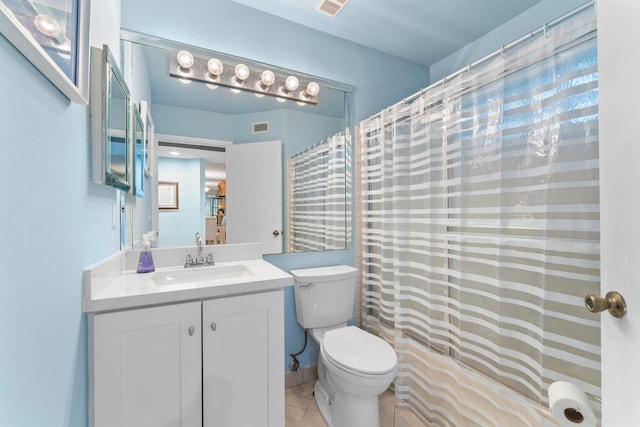 full bathroom with vanity, shower / tub combo with curtain, toilet, and tile patterned floors