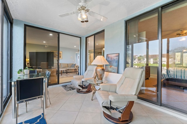 sunroom featuring ceiling fan