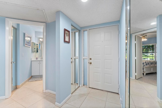 tiled foyer featuring a textured ceiling