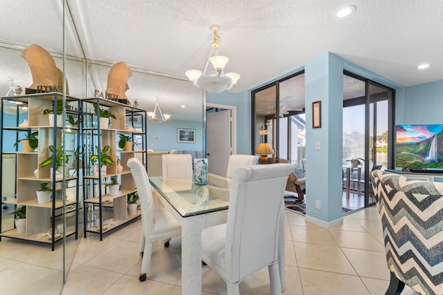 dining space featuring a wall of windows, a textured ceiling, light tile patterned floors, and a notable chandelier