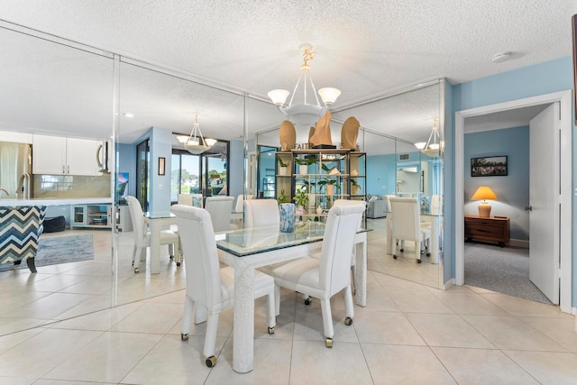 dining room with a notable chandelier, a textured ceiling, and light tile patterned floors