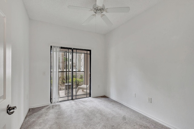 carpeted empty room with a textured ceiling and ceiling fan