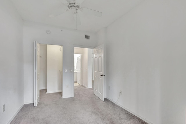 unfurnished bedroom with ceiling fan and light colored carpet