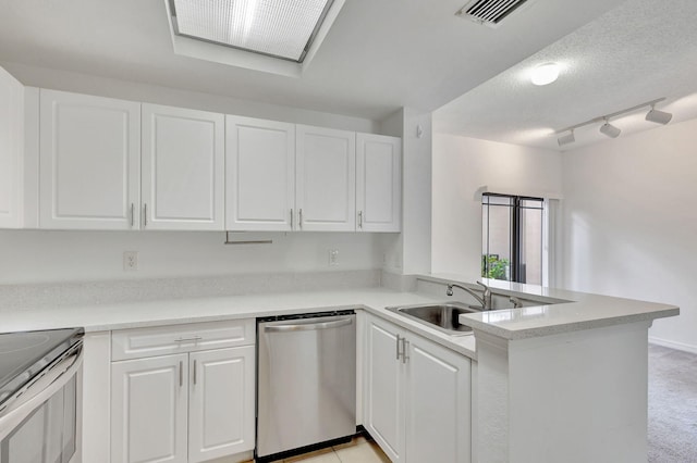 kitchen featuring white cabinets, sink, stainless steel appliances, and kitchen peninsula