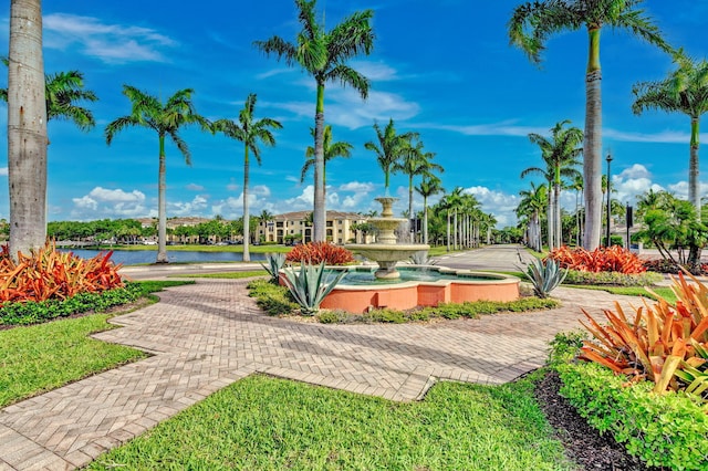 view of property's community with a water view and a yard