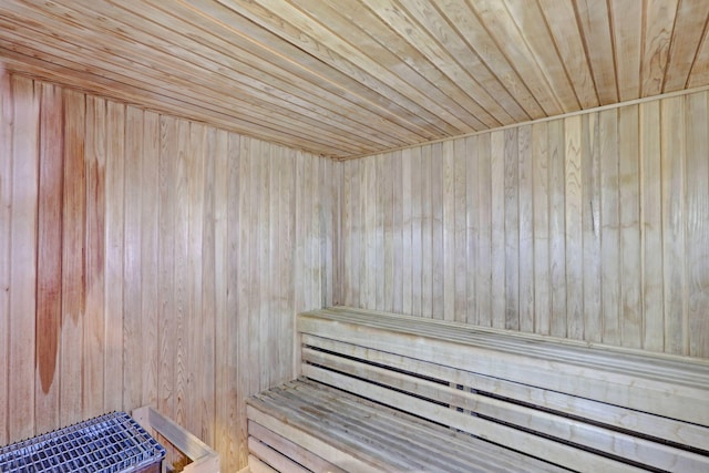 view of sauna with wooden walls and wooden ceiling