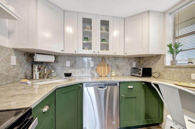 kitchen featuring white cabinets, light stone countertops, stainless steel appliances, green cabinets, and decorative backsplash