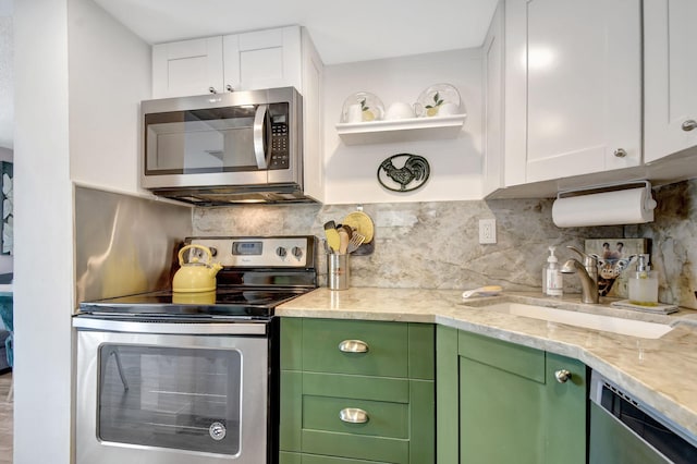 kitchen featuring white cabinets, appliances with stainless steel finishes, and green cabinets