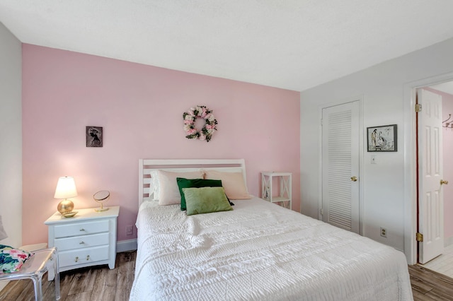 bedroom with light hardwood / wood-style flooring and a closet