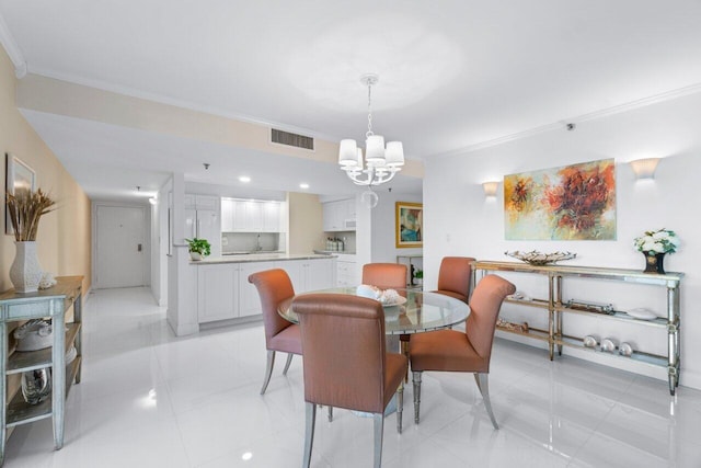 tiled dining space featuring an inviting chandelier and crown molding