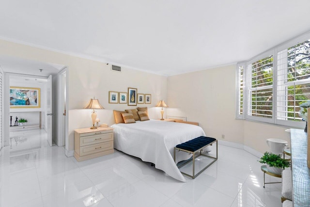 tiled bedroom featuring crown molding