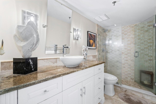 bathroom featuring tile patterned floors, a shower with shower door, vanity, and toilet