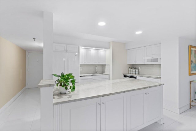 kitchen featuring white cabinets, white appliances, tasteful backsplash, and sink