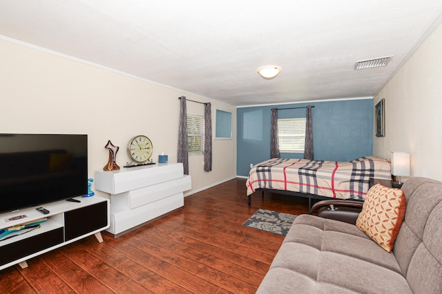 bedroom with dark hardwood / wood-style floors and crown molding