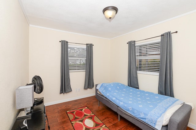 bedroom with dark hardwood / wood-style floors and crown molding