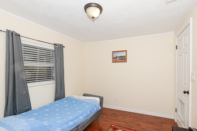 bedroom with ornamental molding and dark hardwood / wood-style flooring