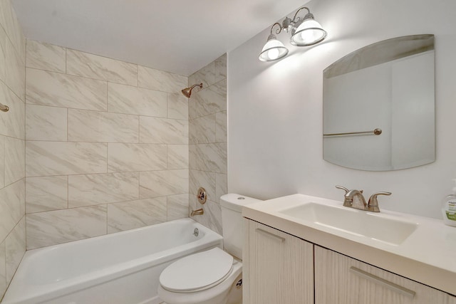 full bathroom featuring tiled shower / bath combo, vanity, and toilet