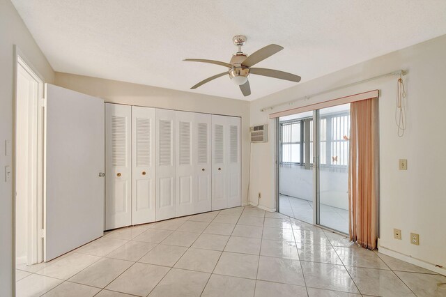 interior space featuring an AC wall unit and ceiling fan