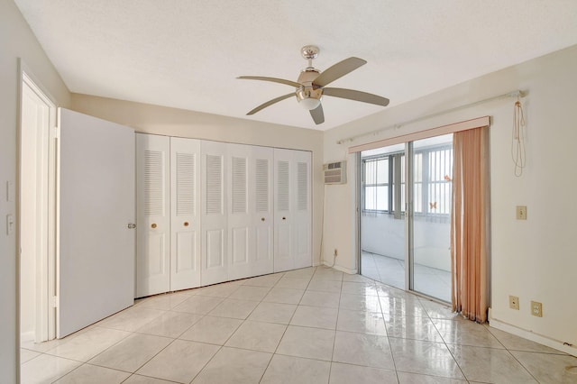 unfurnished bedroom featuring a closet, a textured ceiling, access to outside, light tile patterned floors, and ceiling fan