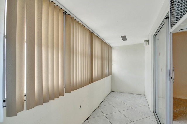 hall with light tile patterned flooring