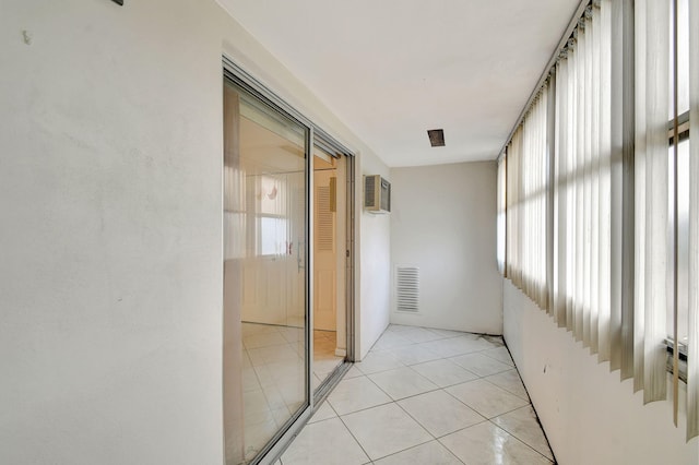 hall featuring light tile patterned floors and a wall mounted air conditioner