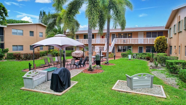 view of home's community featuring a gazebo, a lawn, and a patio area