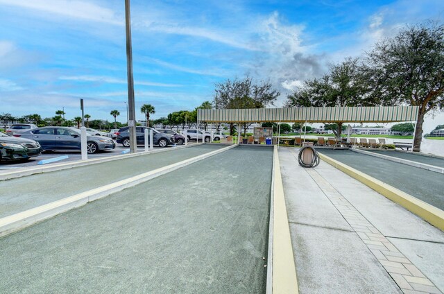 view of car parking featuring a water view