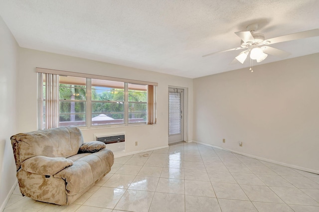 interior space featuring ceiling fan, a textured ceiling, and a wall unit AC