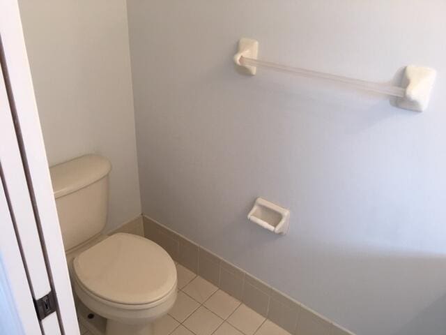 bathroom with toilet and tile patterned floors