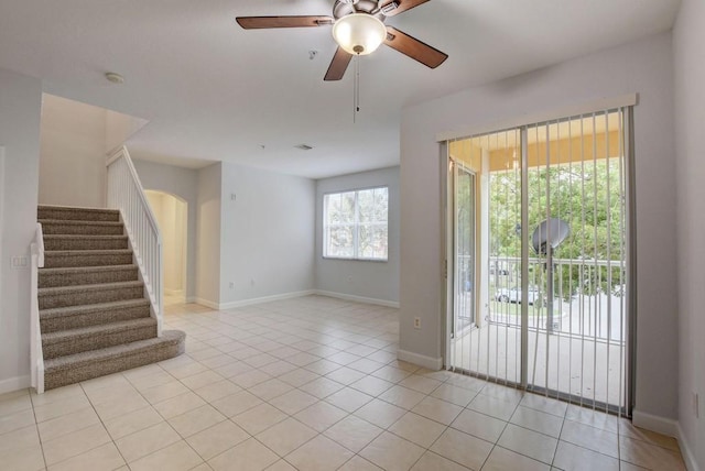 empty room featuring ceiling fan and light tile patterned floors