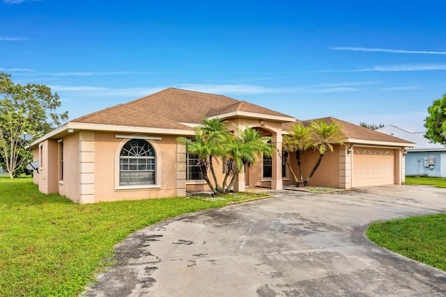 view of front of property with a garage and a front lawn