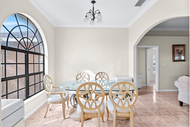 tiled dining room with an inviting chandelier and ornamental molding