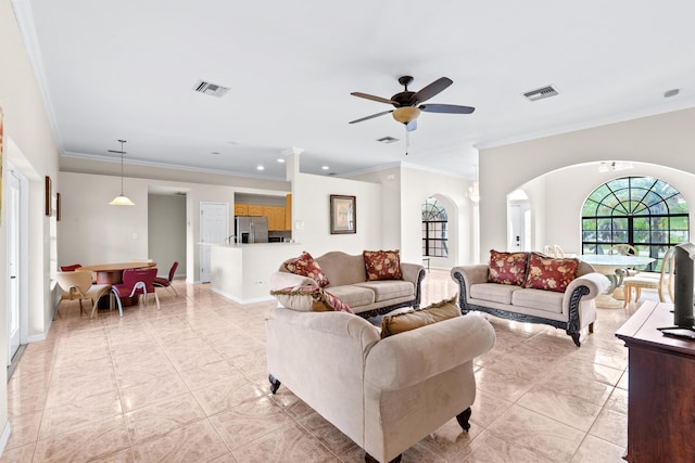 living room featuring ornamental molding, light tile patterned flooring, and ceiling fan