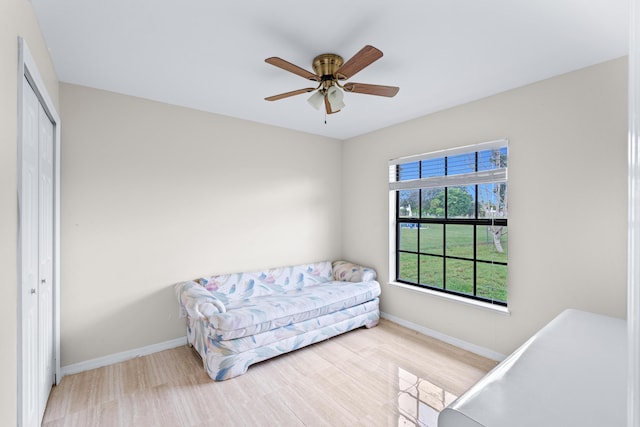 bedroom with light hardwood / wood-style flooring, a closet, and ceiling fan