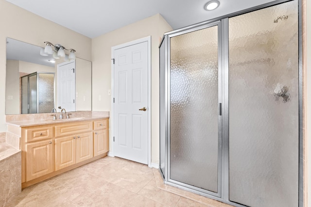 bathroom featuring vanity, a shower with shower door, and tile patterned floors