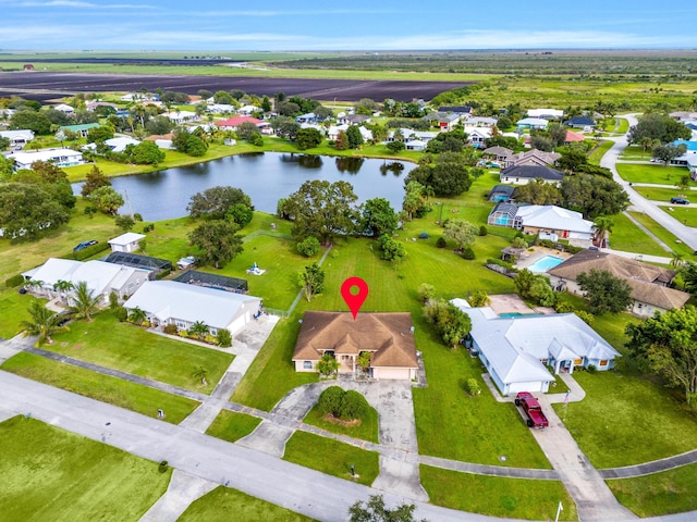 birds eye view of property with a water view