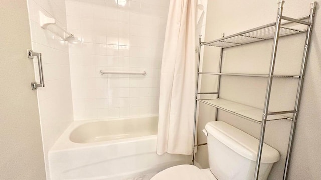 bathroom featuring shower / bath combo with shower curtain and toilet