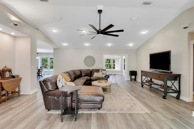 living room with ceiling fan, light hardwood / wood-style floors, a healthy amount of sunlight, and vaulted ceiling