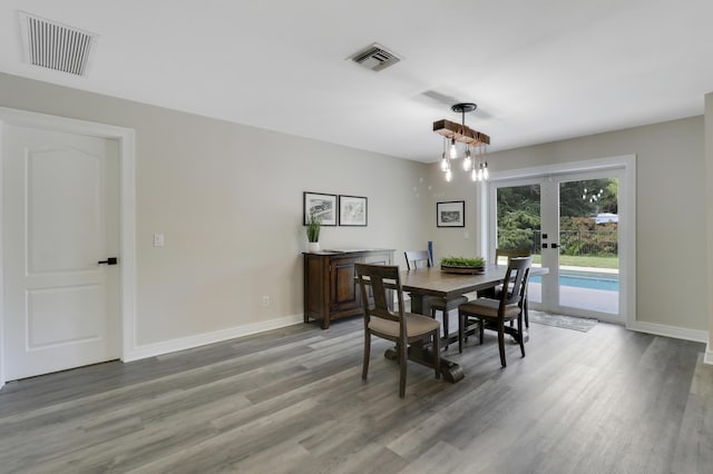 dining space with hardwood / wood-style floors and french doors